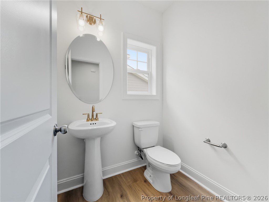 154 Carver Street Carthage, NC 28327 - Photo 8 of 41 a bathroom with a toilet a sink and mirror