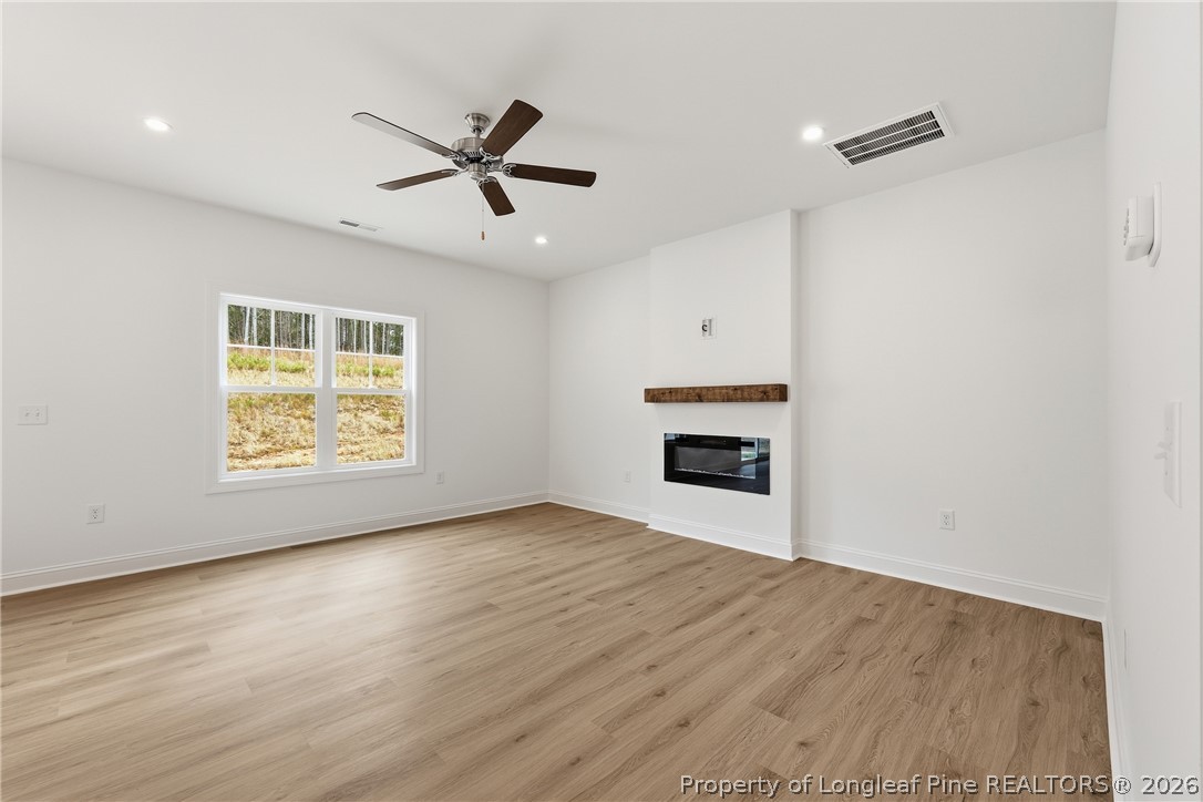 154 Carver Street Carthage, NC 28327 - Photo 9 of 41 a view of an empty room with a window and fireplace