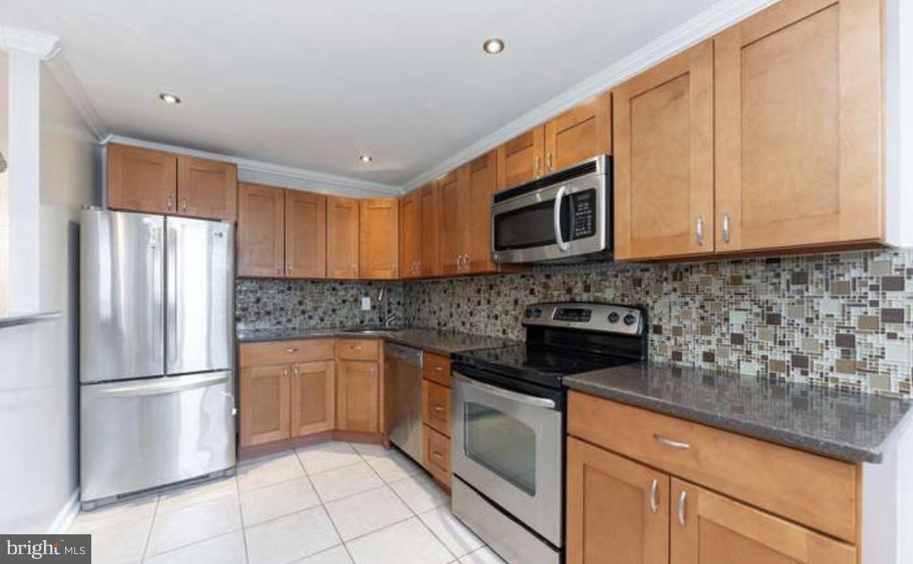 10869 Harrow Road Philadelphia, PA 19154 - Photo 7 of 10 a kitchen with stainless steel appliances granite countertop a refrigerator sink and cabinets
