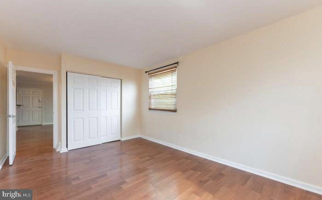 10869 Harrow Road Philadelphia, PA 19154 - Photo 8 of 10 an empty room with wooden floor and windows