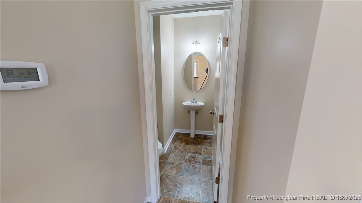541 Roanoke Drive Raeford, NC 28376 - Photo 11 of 25 a bathroom with a granite countertop sink a mirror and a shower