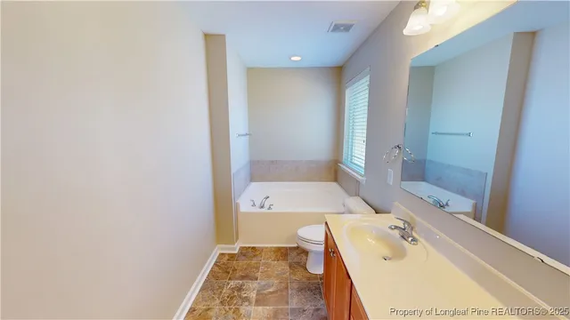 a bathroom with a tub sink and shower