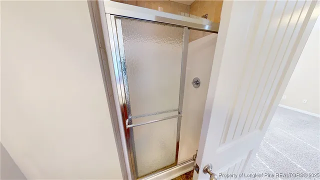 a bathroom with a glass door shower
