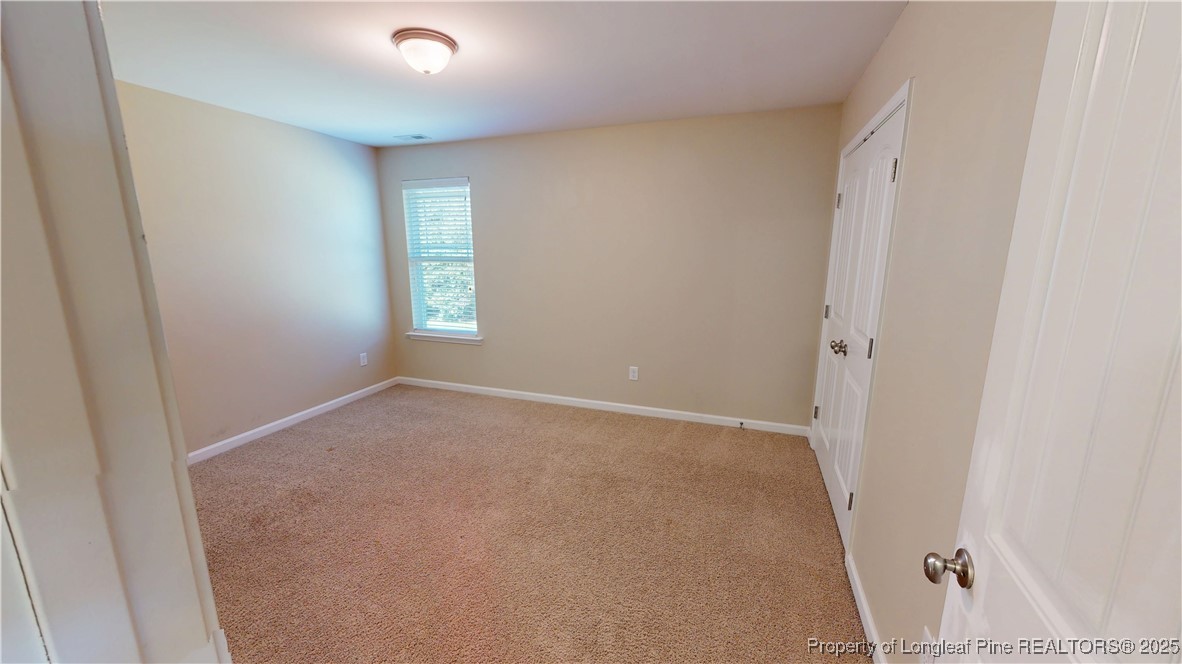 541 Roanoke Drive Raeford, NC 28376 - Photo 23 of 25 an empty room with windows and closet