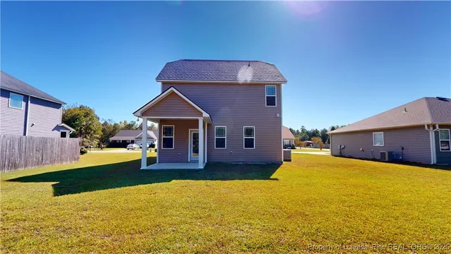 a front view of house with yard and garage