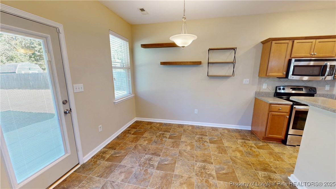 541 Roanoke Drive Raeford, NC 28376 - Photo 7 of 25 a view of a kitchen with wooden floor and electronic appliances