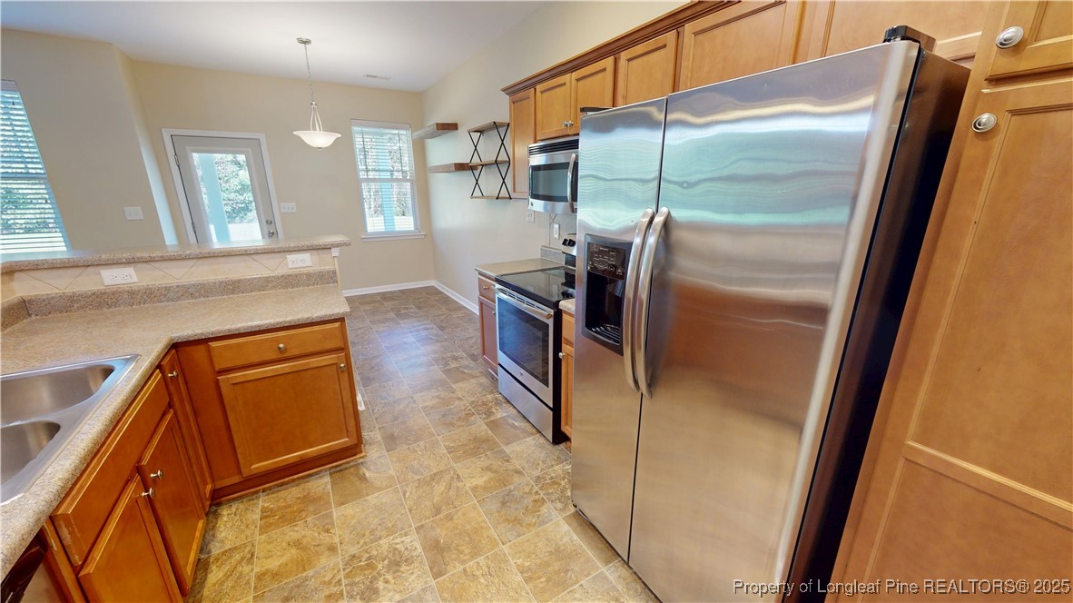 541 Roanoke Drive Raeford, NC 28376 - Photo 9 of 25 a kitchen with a refrigerator and a sink