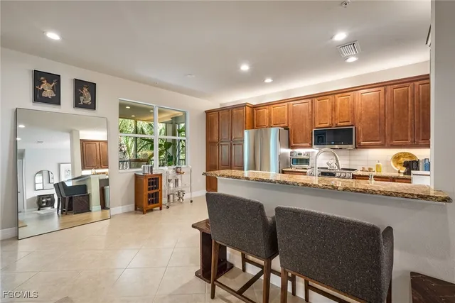 a kitchen with stainless steel appliances granite countertop sink microwave and stove