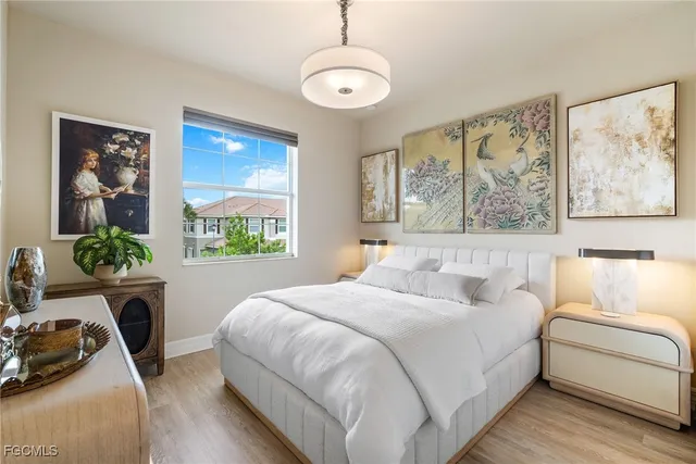 a bedroom with a bed a couch and a window