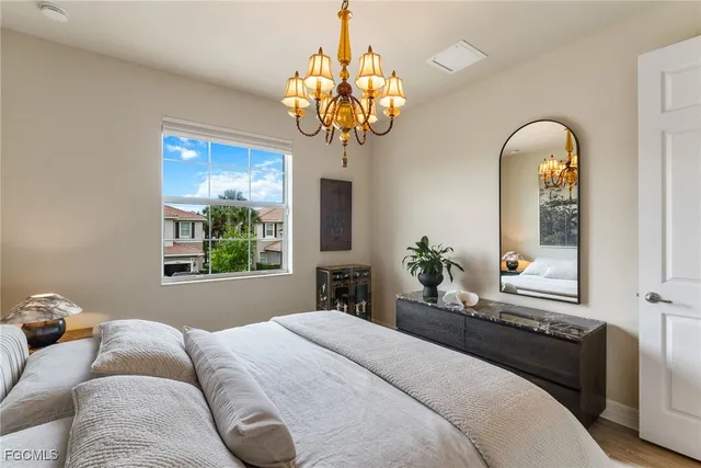 a bedroom with a bed and a chandelier