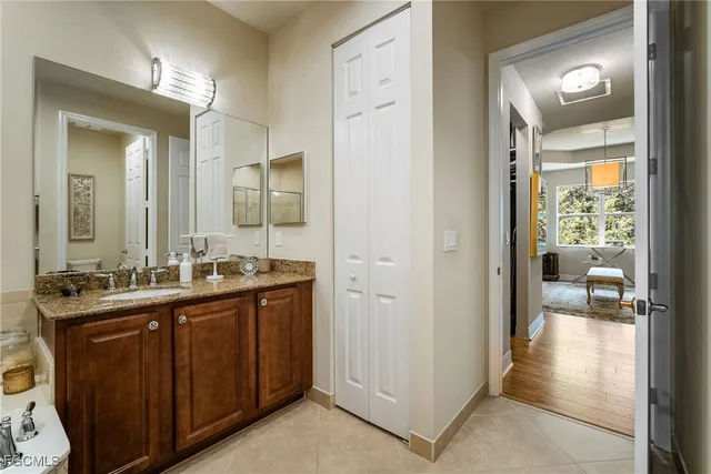 a en suite bathroom with a sink mirror and a shower