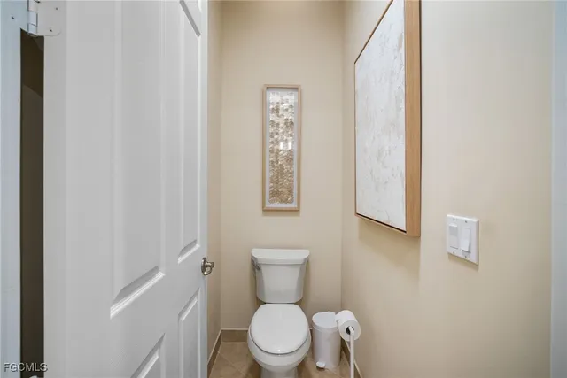 a white toilet sitting next to a bathroom sink