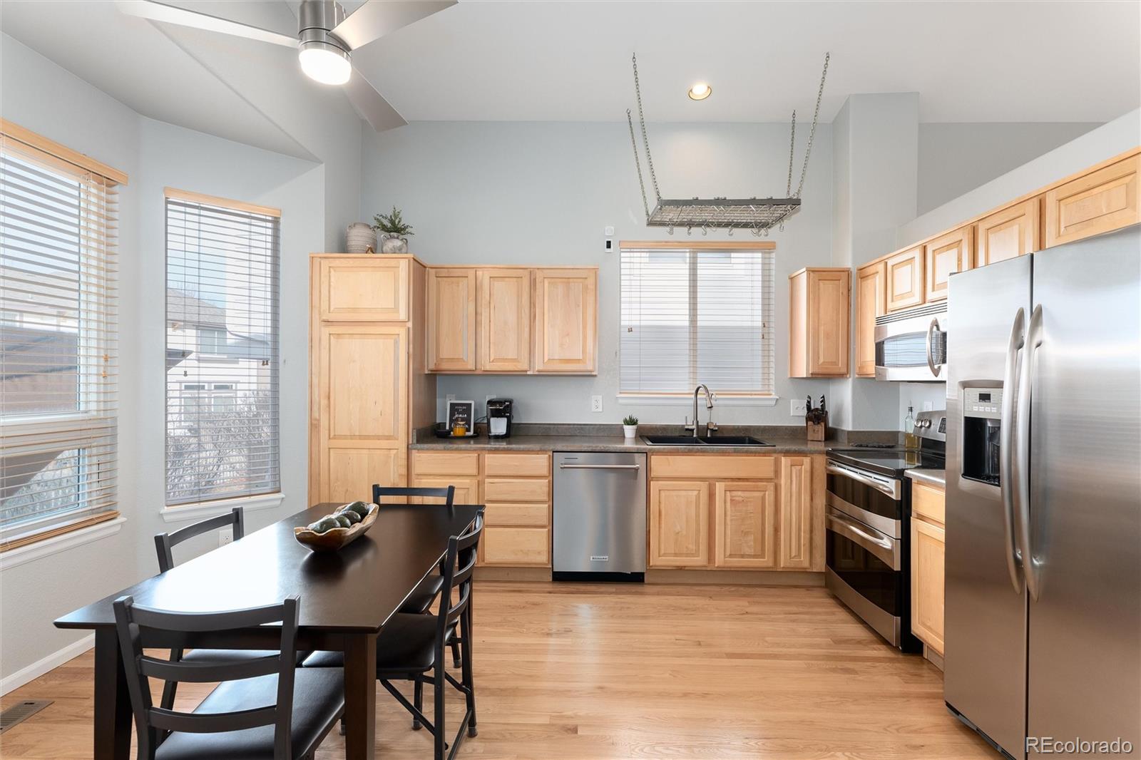 10627 Cherrybrook Circle Highlands Ranch, CO 80126 - Photo 14 of 44 a kitchen with stainless steel appliances granite countertop a stove refrigerator sink and cabinets