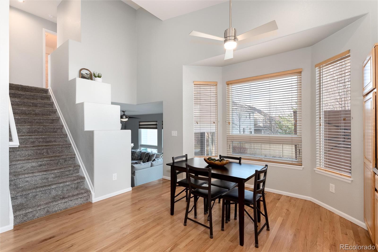 10627 Cherrybrook Circle Highlands Ranch, CO 80126 - Photo 15 of 44 a view of a dining room with furniture and wooden floor