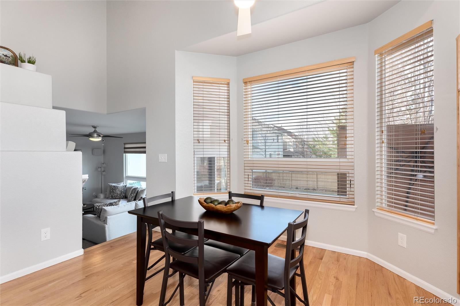 10627 Cherrybrook Circle Highlands Ranch, CO 80126 - Photo 16 of 44 a view of a dining room with furniture and wooden floor