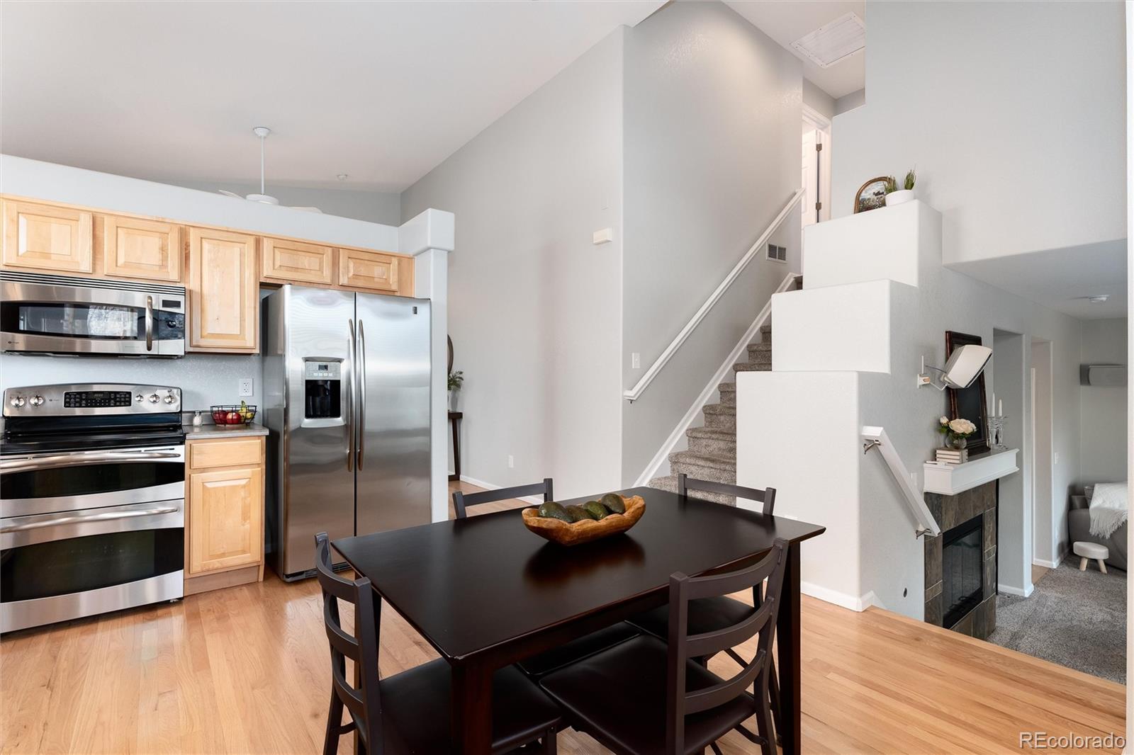 10627 Cherrybrook Circle Highlands Ranch, CO 80126 - Photo 17 of 44 a view of a dining room with furniture kitchen and wooden floor