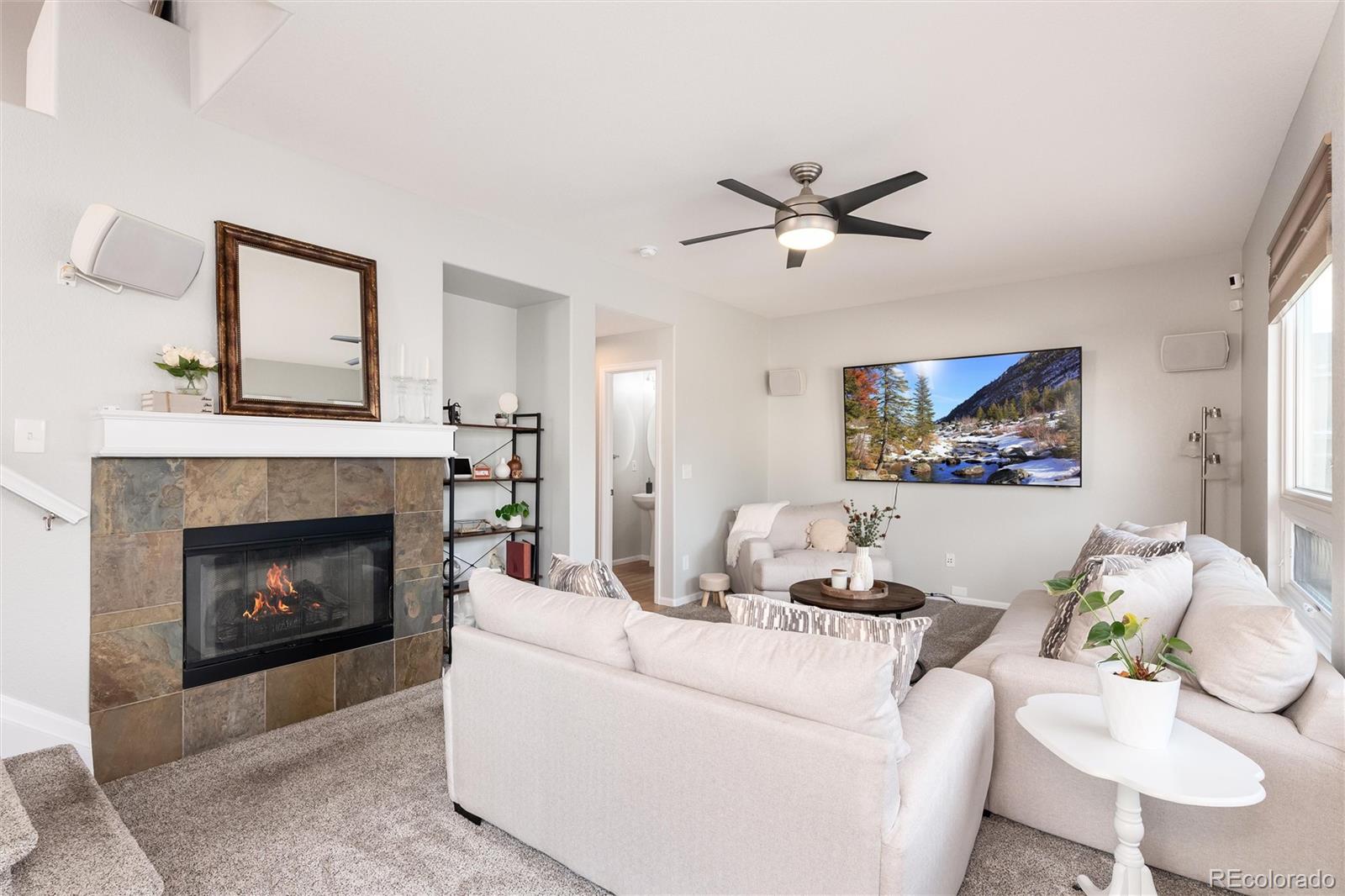10627 Cherrybrook Circle Highlands Ranch, CO 80126 - Photo 19 of 44 a living room with furniture and a fireplace