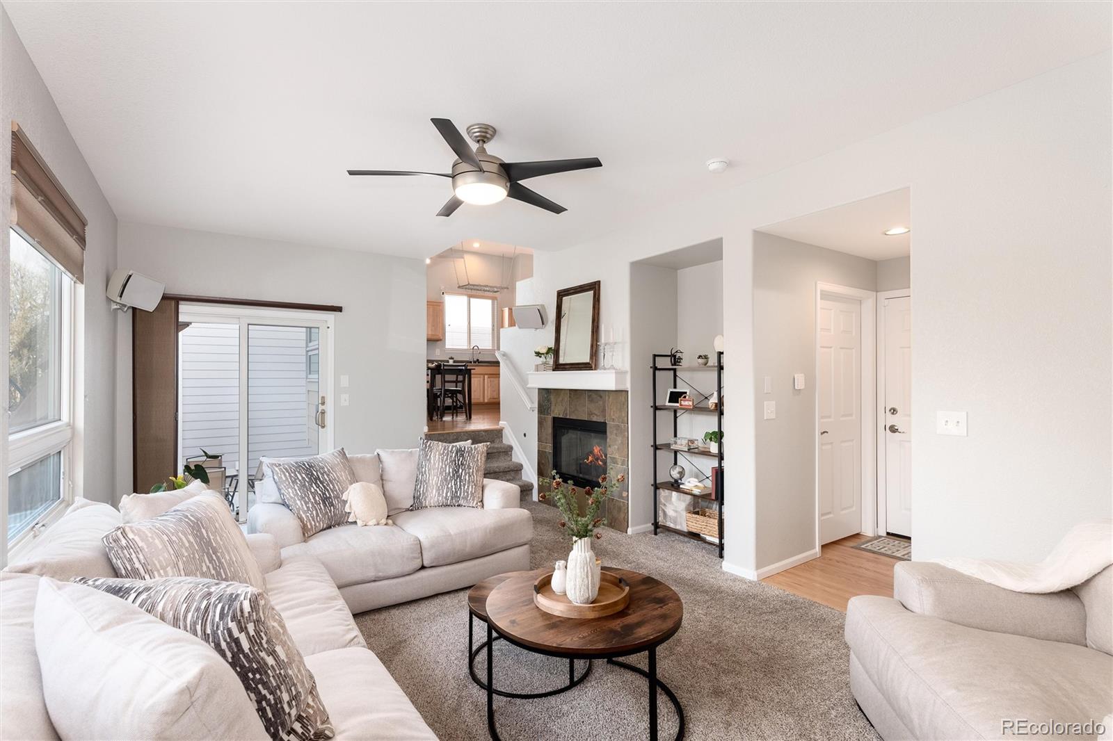 10627 Cherrybrook Circle Highlands Ranch, CO 80126 - Photo 22 of 44 a living room with furniture a fireplace and a large window