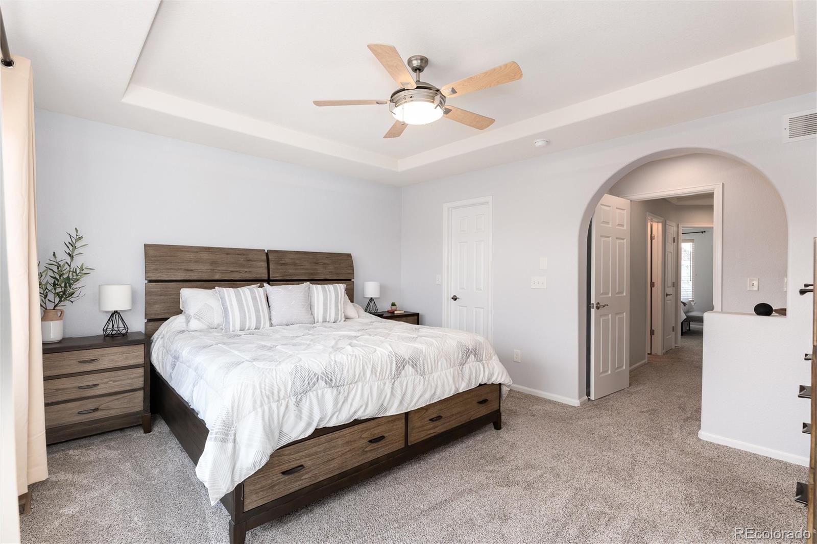 10627 Cherrybrook Circle Highlands Ranch, CO 80126 - Photo 30 of 44 a bedroom with a bed and a ceiling fan