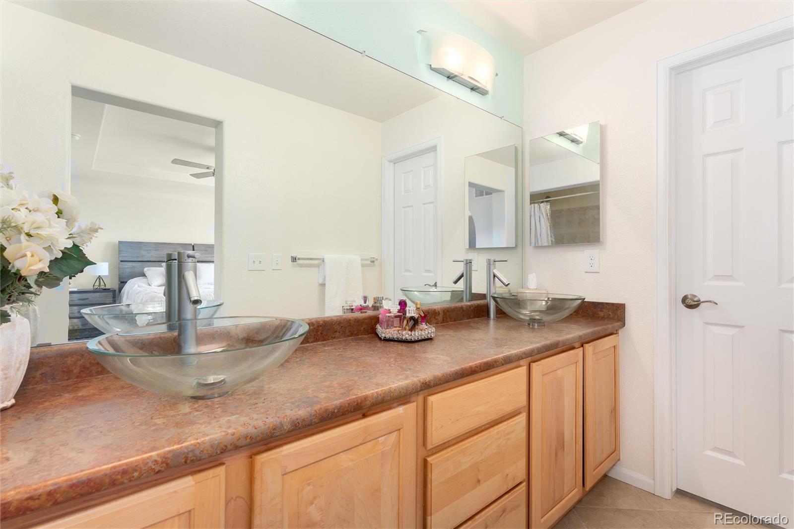 10627 Cherrybrook Circle Highlands Ranch, CO 80126 - Photo 32 of 44 a bathroom with a sink double vanity and a mirror