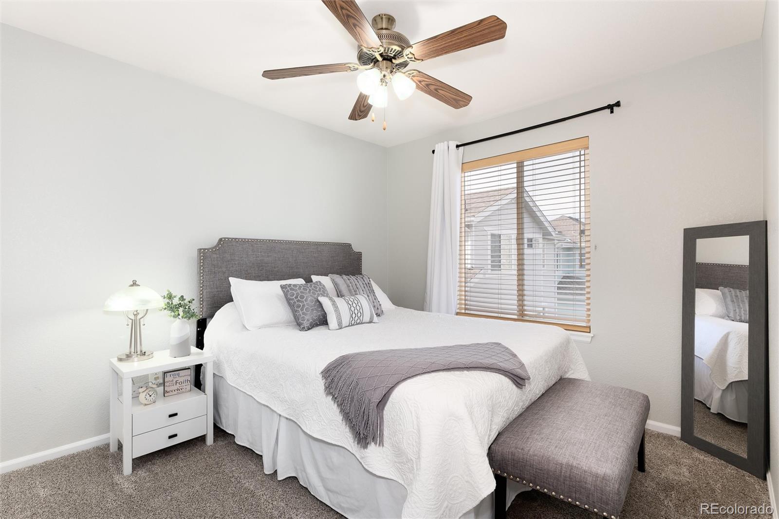 10627 Cherrybrook Circle Highlands Ranch, CO 80126 - Photo 36 of 44 a bedroom with a bed and a chandelier