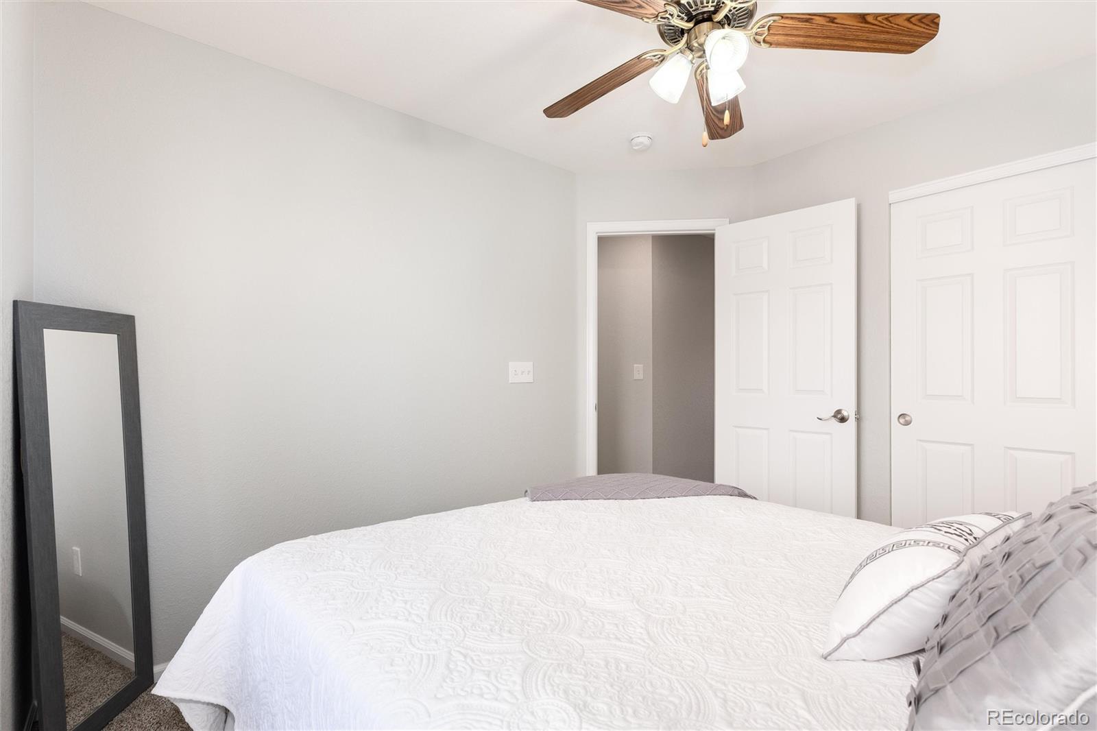 10627 Cherrybrook Circle Highlands Ranch, CO 80126 - Photo 37 of 44 a bedroom with a bed and a ceiling fan
