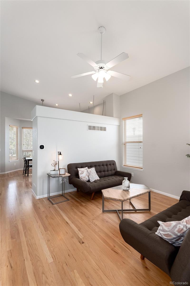 10627 Cherrybrook Circle Highlands Ranch, CO 80126 - Photo 4 of 44 a living room with furniture and a wooden floor