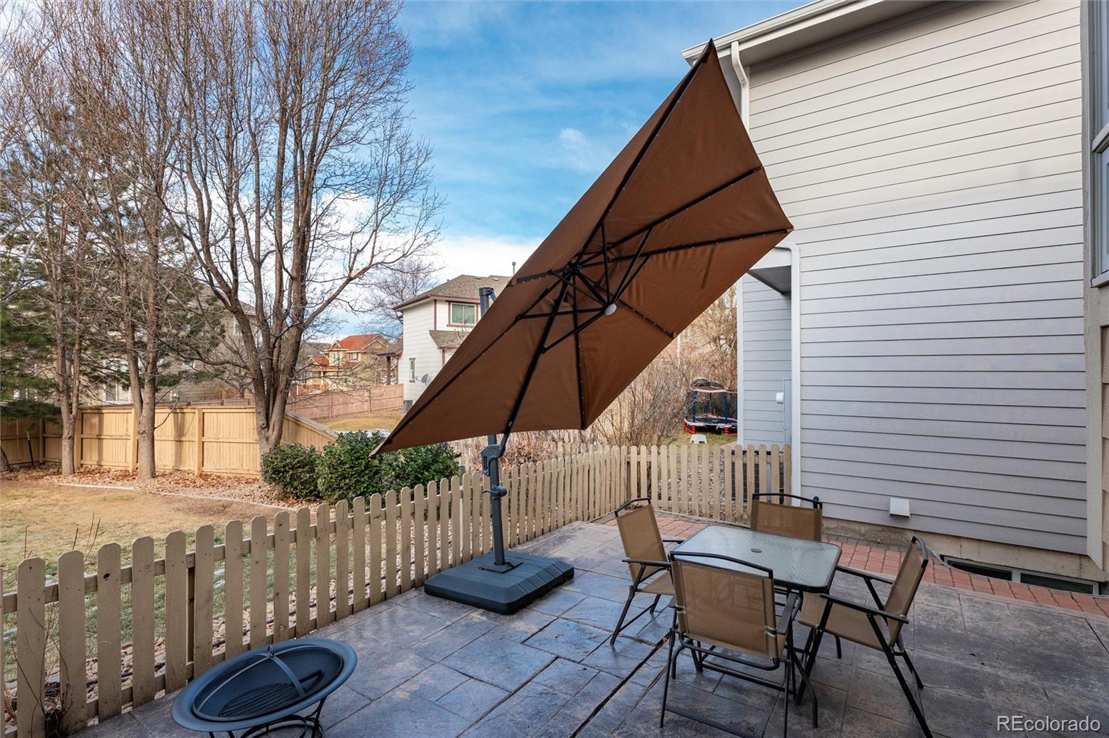 10627 Cherrybrook Circle Highlands Ranch, CO 80126 - Photo 41 of 44 a backyard of a house with table and chairs
