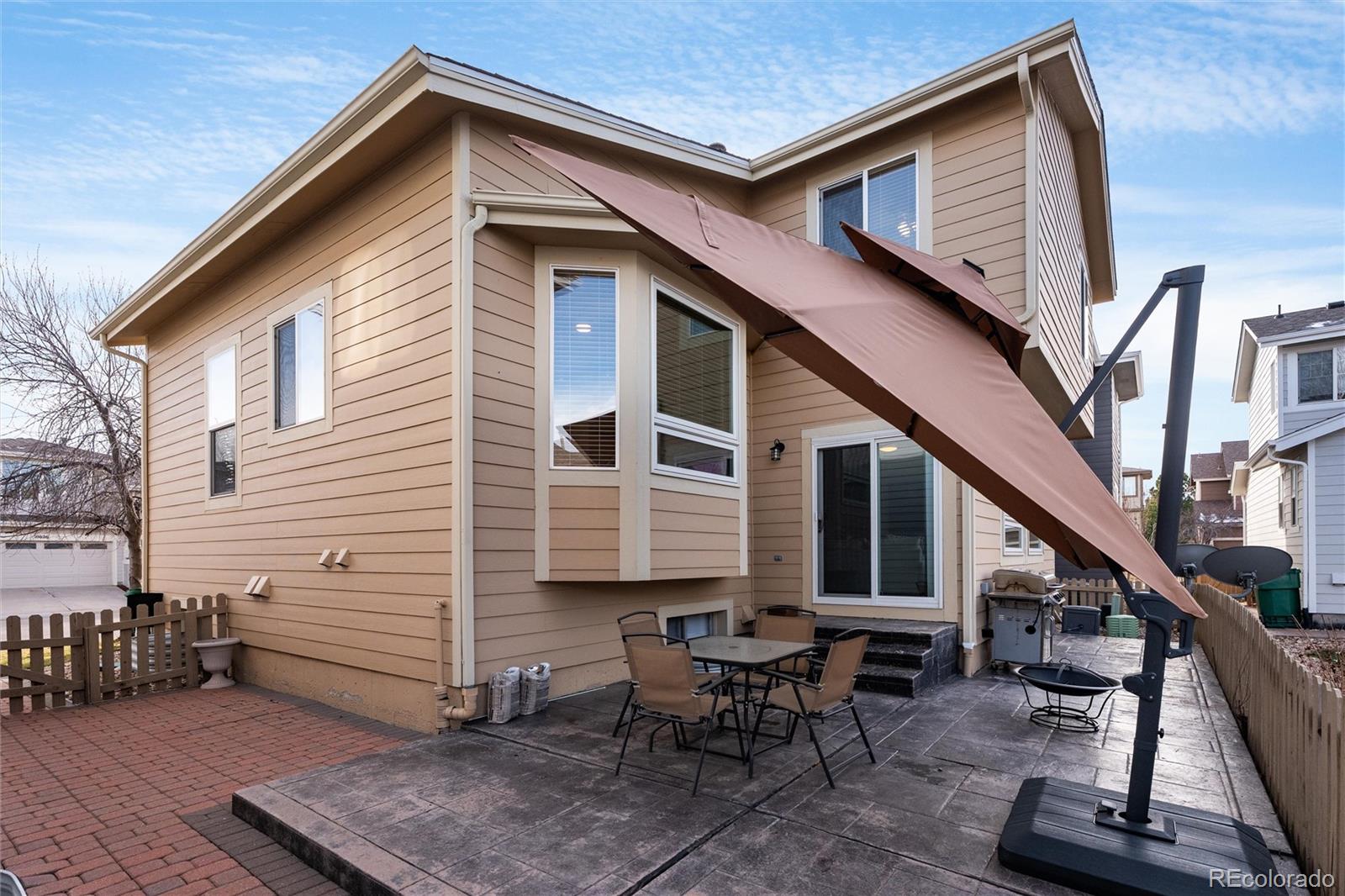 10627 Cherrybrook Circle Highlands Ranch, CO 80126 - Photo 44 of 44 a backyard of a house with table and chairs