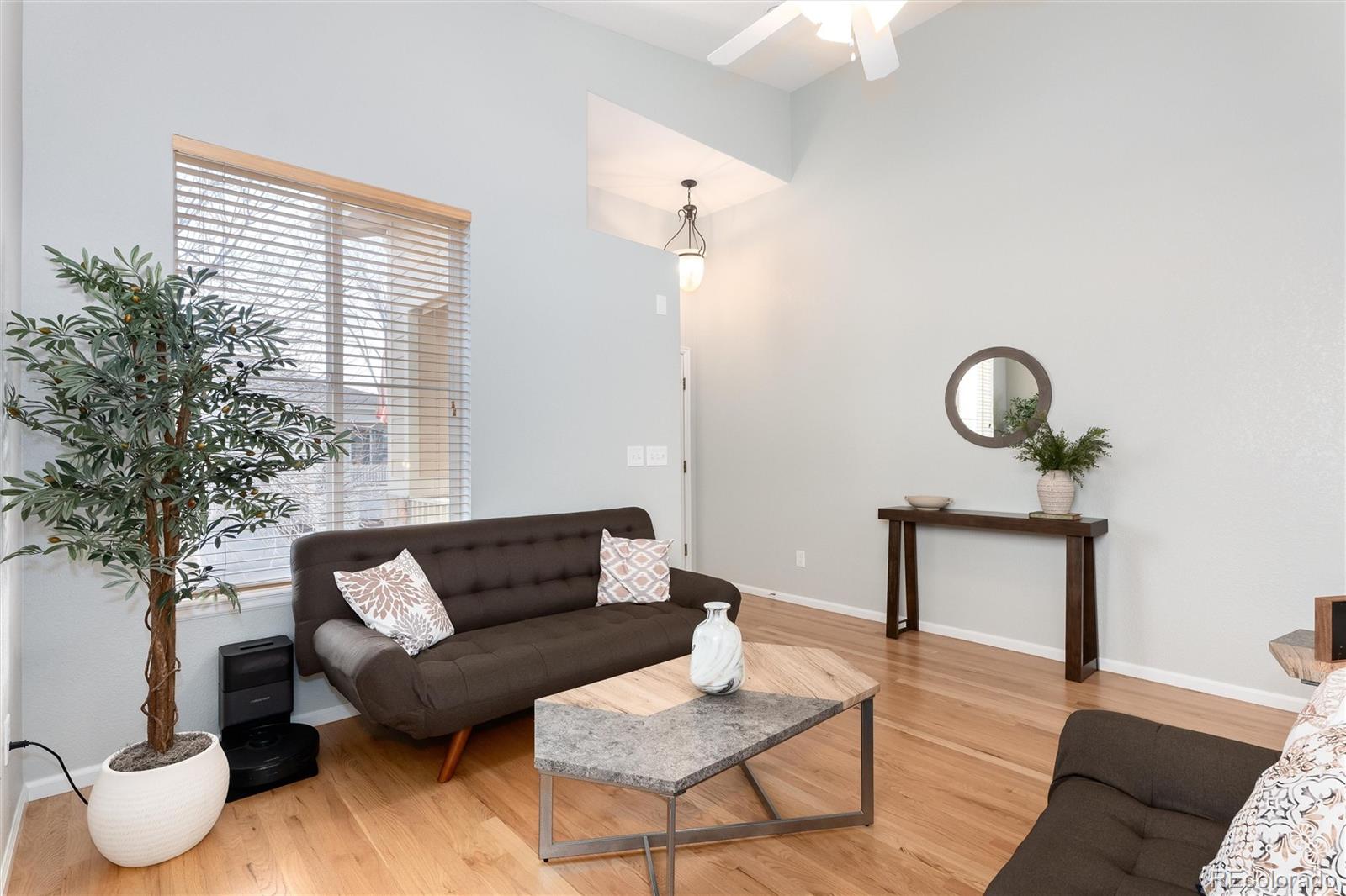 10627 Cherrybrook Circle Highlands Ranch, CO 80126 - Photo 8 of 44 a living room with furniture and a potted plant