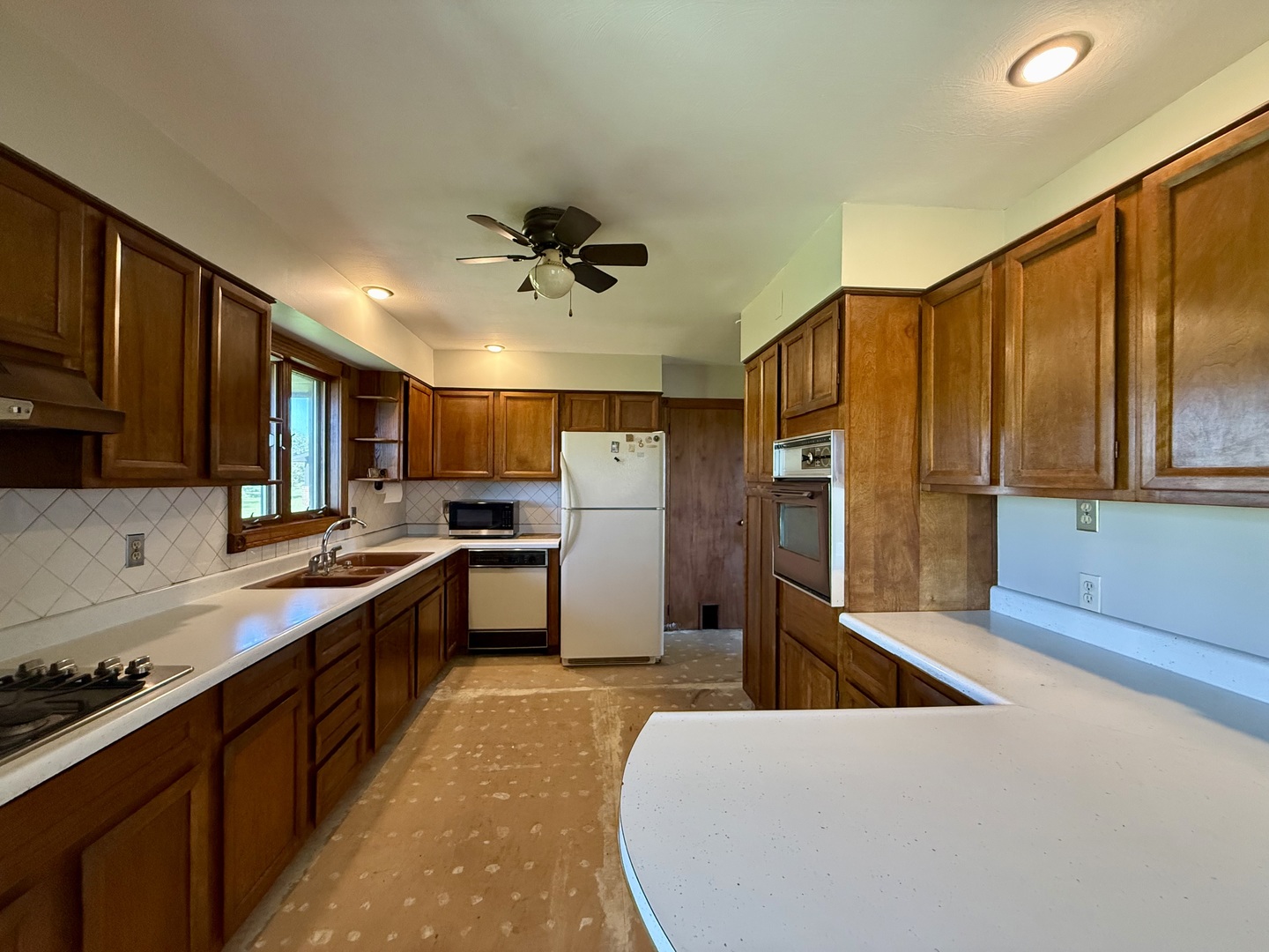 2052 County Road 3000 North Rantoul, IL 61866 - Photo 9 of 21 a large kitchen with stainless steel appliances a large counter top a sink a stove a refrigerator cabinets and living room view