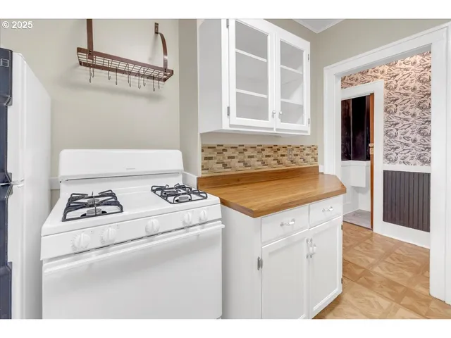 a kitchen with a stove and a refrigerator