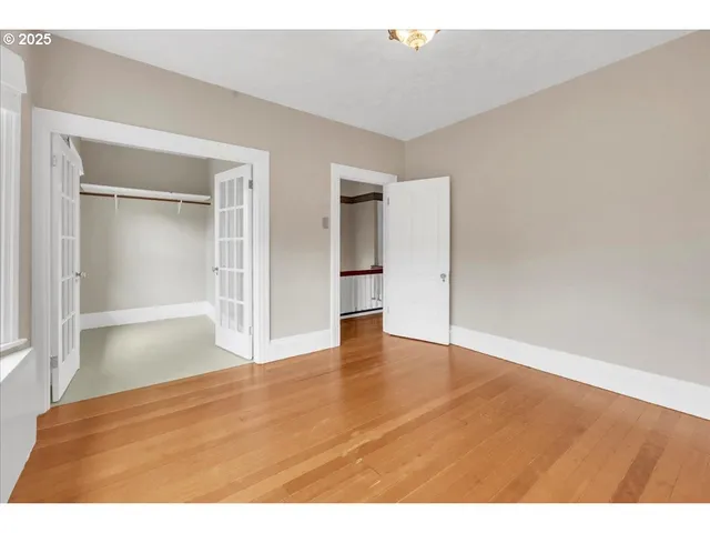 a view of an empty room and wooden floor