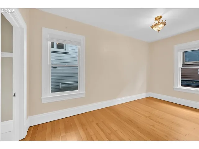 a view of empty room with window and fireplace