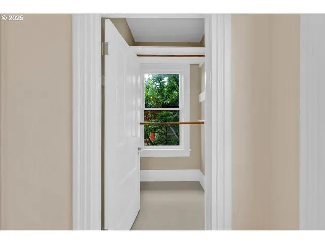a view of a hallway with wooden floor and entryway