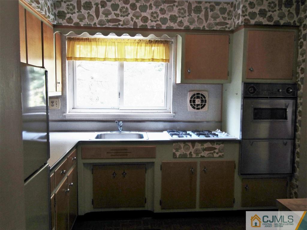30 Hill Road Edison, NJ 08817 - Photo 8 of 17 a kitchen with a sink a window and cabinets