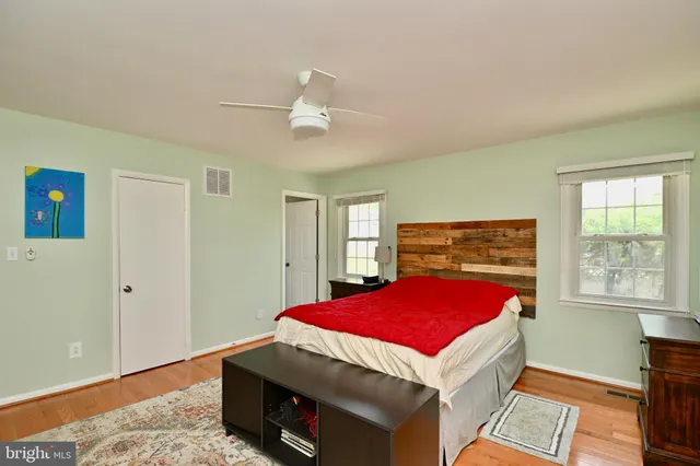 a room with pool table and windows