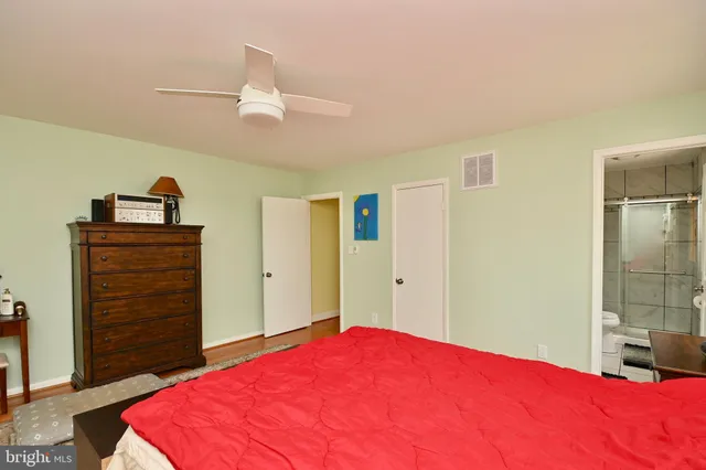 a bedroom with a bed and a dresser