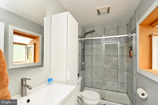 a bathroom with a sink toilet and shower