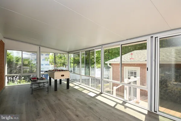 a living room with furniture and floor to ceiling windows