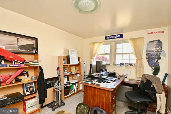 a view of a workspace with furniture and a window