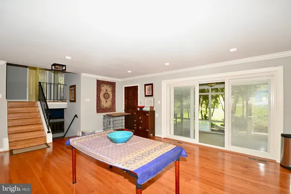 a view of a livingroom with furniture wooden floor and window