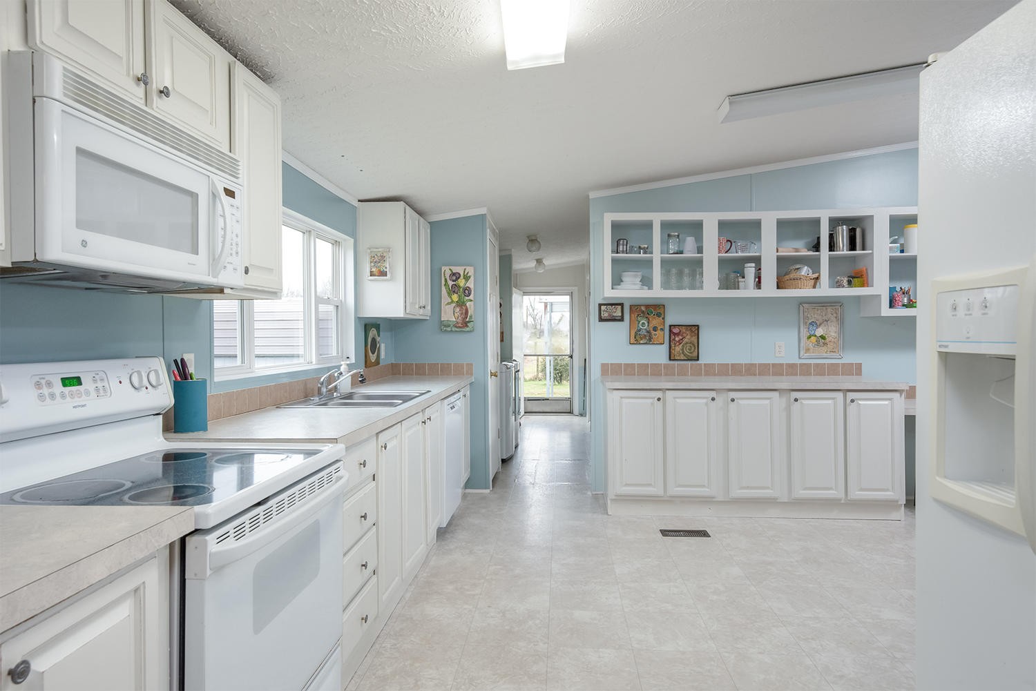 929 Hunt Road Cleveland, TN 37323 - Photo 8 of 26 a kitchen with white cabinets and sink