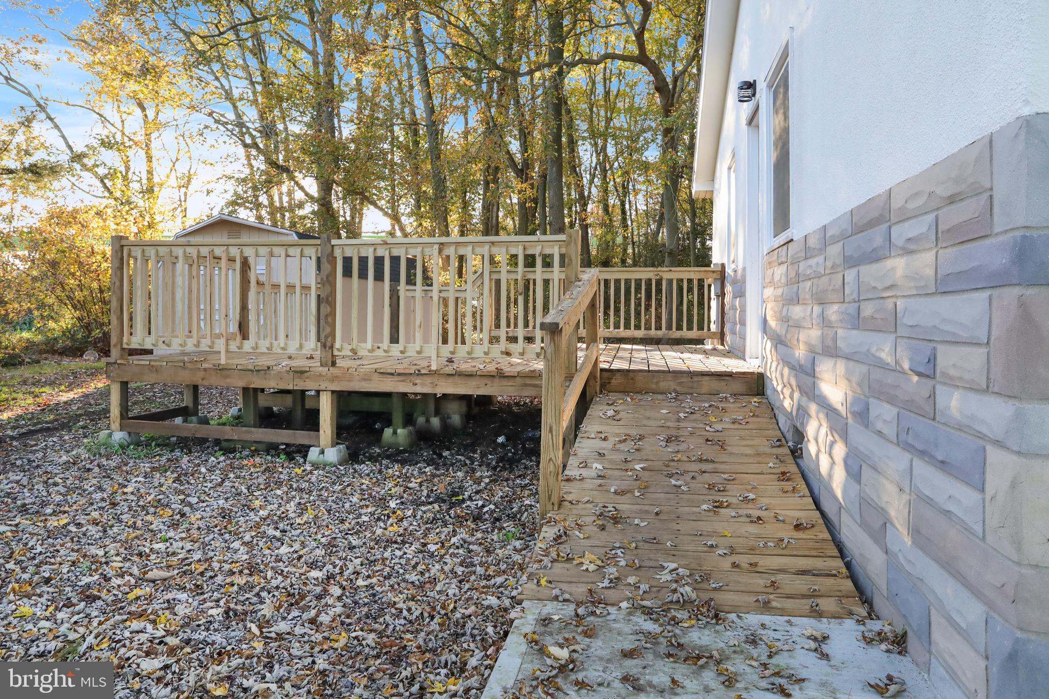 28154 Venton Road Princess Anne, MD 21853 - Photo 33 of 34 a porch with a bench next to yard