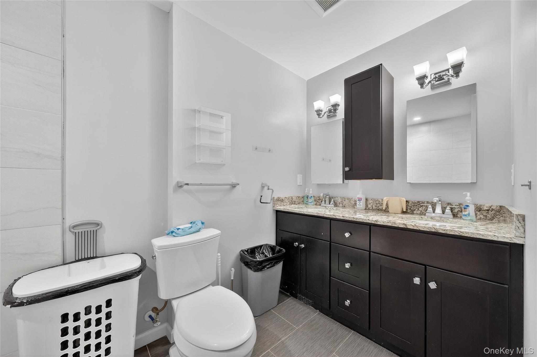 155 Roselawn Road Highland Mills, NY 10930 - Photo 25 of 40 a bathroom with a toilet sink double vanity and mirror