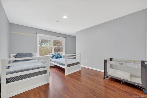 a bedroom with furniture and wooden floor