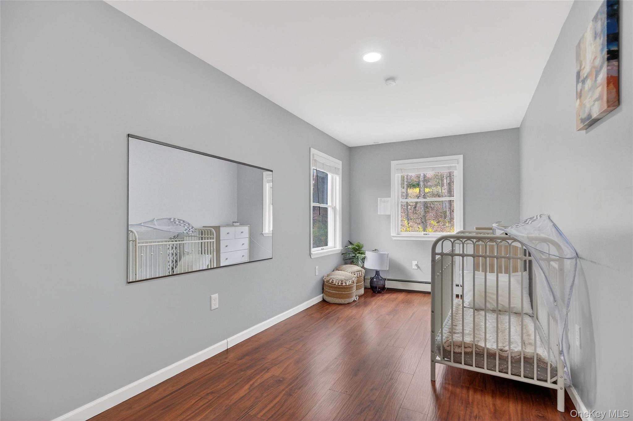 155 Roselawn Road Highland Mills, NY 10930 - Photo 27 of 40 a bedroom with a bed and wooden floor