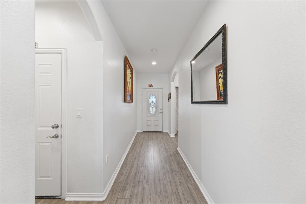 0 Ewing Road Ferris, TX 75125 - Photo 4 of 29 Bright hallway featuring wood-finish flooring, white baseboards, and recessed lighting