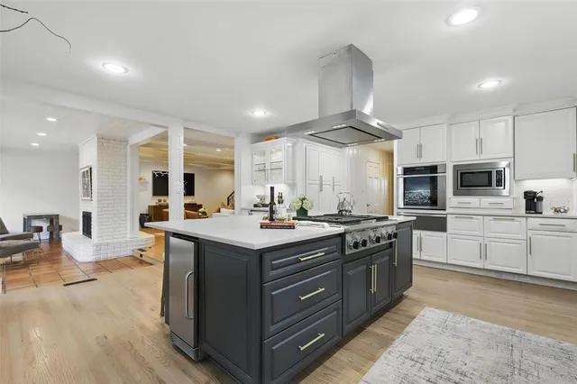 a kitchen with stainless steel appliances granite countertop a stove and a sink