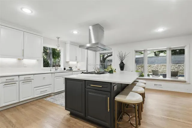 a kitchen with a sink cabinets and wooden floor
